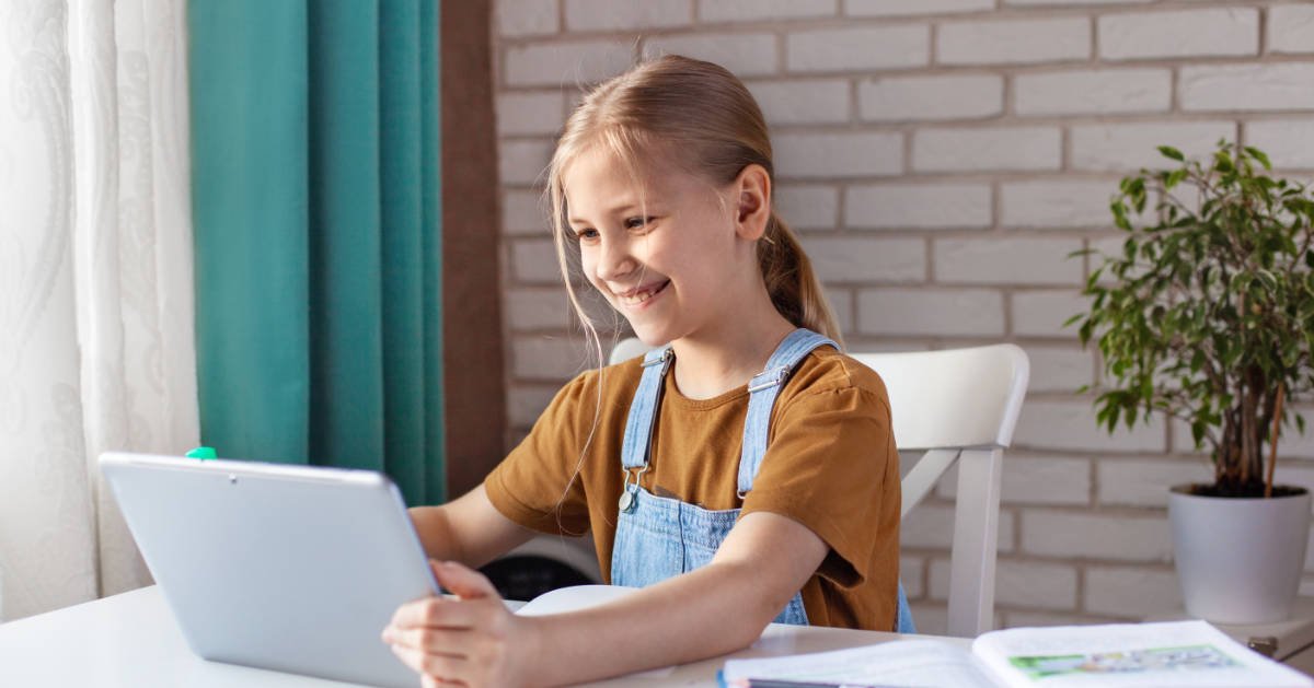 A parent and child reviewing online school lessons together at home
